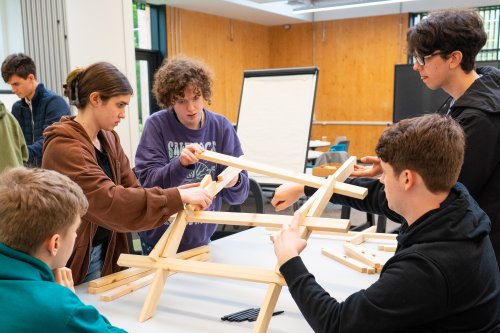 Young people working on a divinci bridge at an NMITE open day