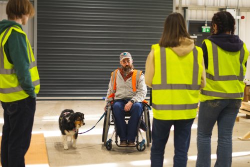 people in warehouse in high vis