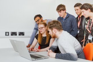 NMITE Students gathered around a laptop
